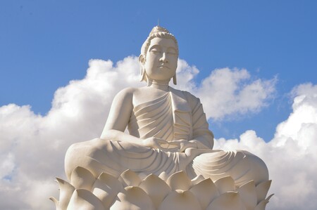 a Buddha statue against a blue sky, representing Buddhanature