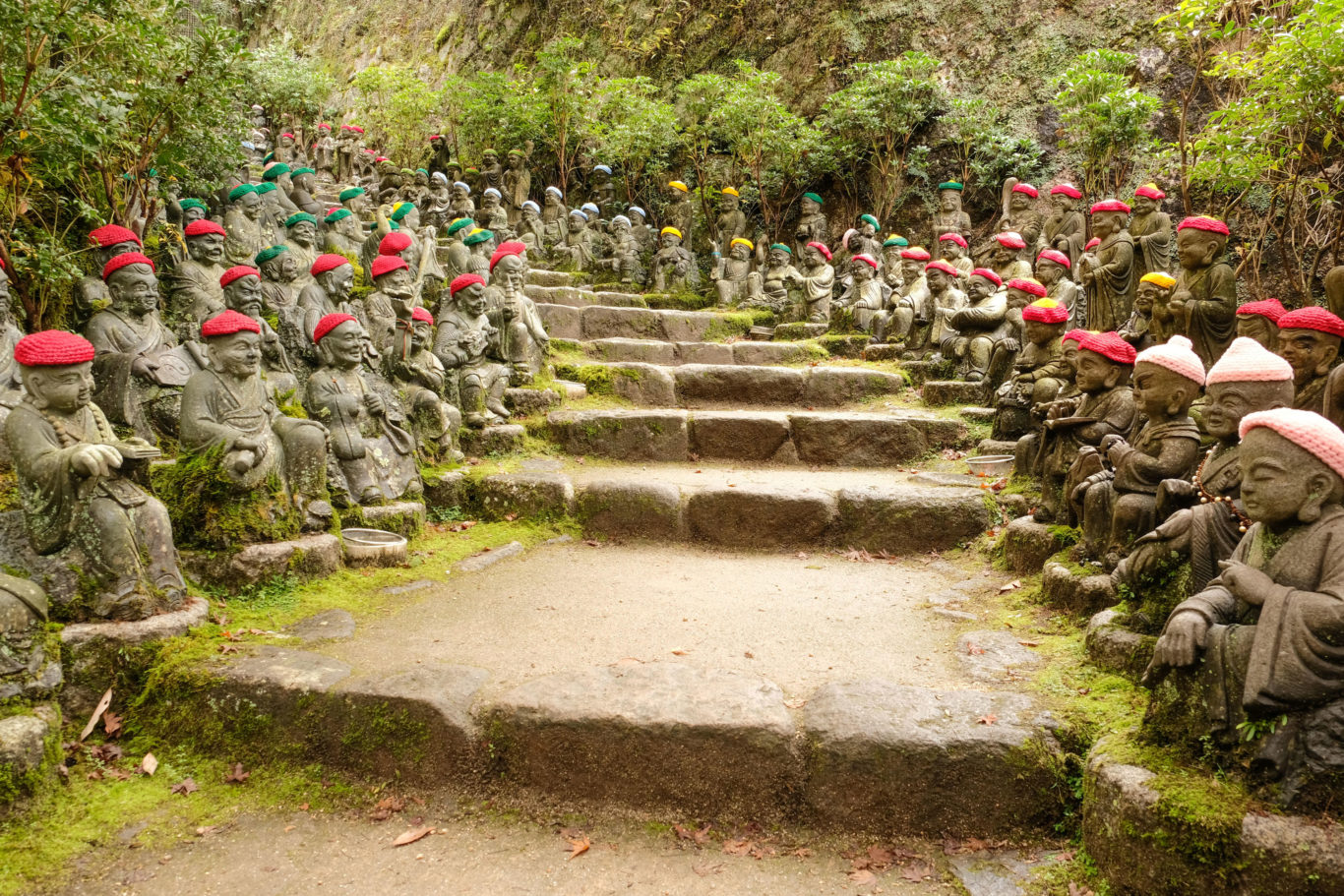 numerous jizo buddha statues, which are regarded as protectors for children and unborn babies