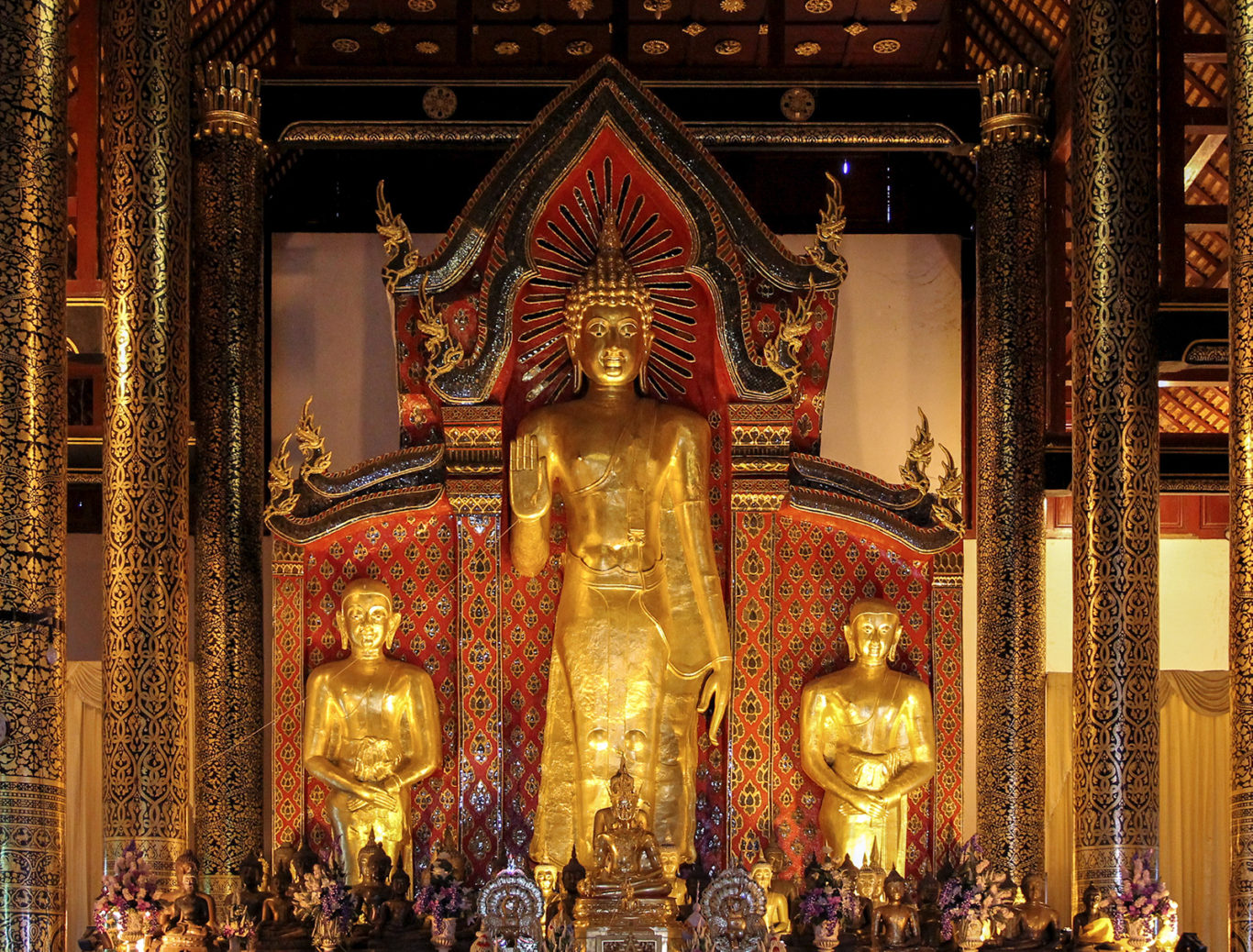 statues of sariputra and maudgalyayana flanking the buddha