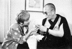 The Dalai Lama receives a small golden tricycle from Editor Helen Tworkov.