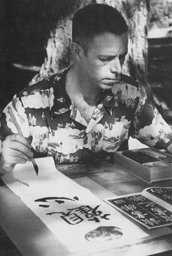  Alan Watts doing Chinese calligraphy, 1958. Photo by Ken Kay.
