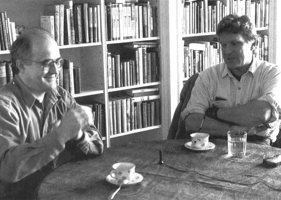A black and white photo of Stephen Batchelor and Robert Thurman discussing reincarnation
