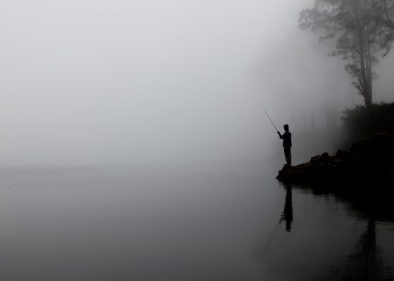 black and white photo of person fishing, shenpa