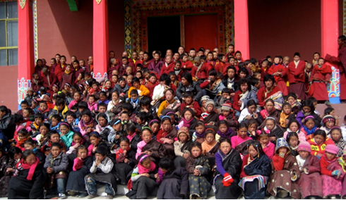School children seated on the steps of the Surmang Shedra