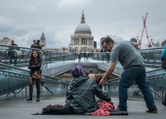 man helps homeless person image for story by Colin Beavan