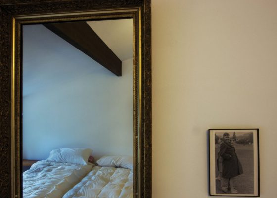 photograph of a bed seen through a mirror for a story called a life too long