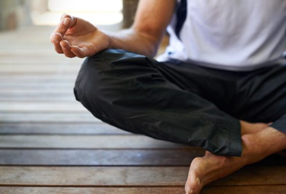 Person sitting cross-legged in meditation