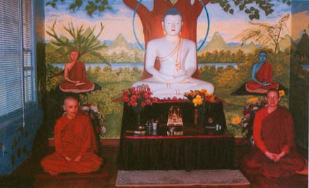 Ven. Sucinta and Ven. Sudhamma in front of the Carolina Buddhist Vihara's main altar; © Jeff Wilson