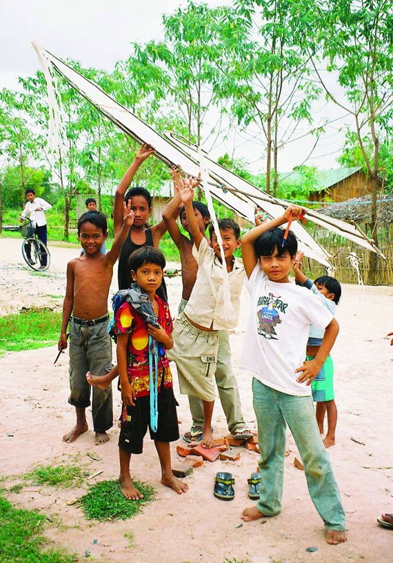 Wat Opot children displaying the traditional singing kite they built in 2008. Its music is an offering of thanks to the god of the wind for fair weather for the rice harvest. 