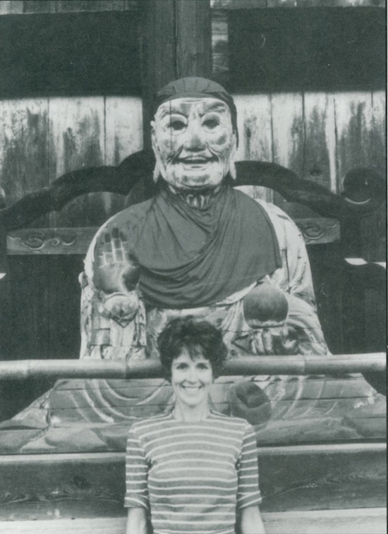 Joanne Kyger in Nara, Japan in front of an Arhat, 1964.