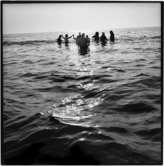 Image 5: For many who once made their living from the sea, returning to the water after the tsunami was too horrible to contemplate. Here a group of Thai villagers enter the water up to their wasists as apart of a trauma recovery program called Making Waves.  