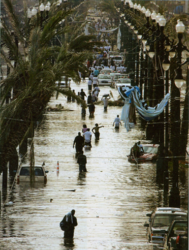 Residents walk through floodwaters on Canal Street in New Orleans on August 30, 2005, after Hurricane Katrina devastated the Louisiana and Mississippi coasts. AP Photo/Bill Haber