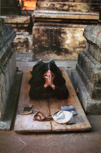 A devotee worshipping at Bodh Gaya, India, the site of the Buddha's enlightenment.