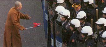 A Buddhist Nun confronting riot police outside Nationalist Party headquarters in Taipei in 2000 ©Reuters/Corbis