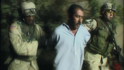 Yunis Abbas being arrested as seen in The Prisoner, Courtesy of Nomados LLC/Red Envelope Entertainment 