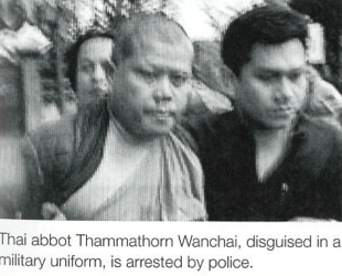  Thai abbot Thammathorn Wanchai, disguised in a military uniform, is arrested by police. AP/Worldwide Photos