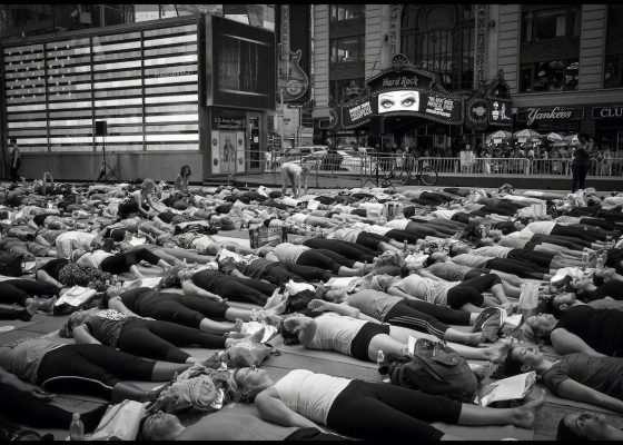 people in savasana in Times Square