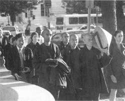 Thich Nhat Hanh (with hat) arrives in Washington, DC. © Mark Phillips