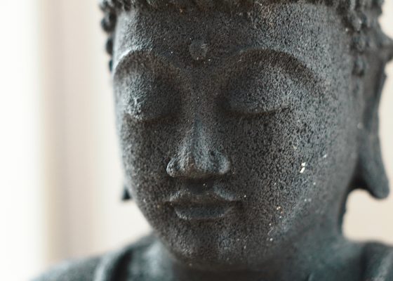 close-up photo of a buddha statue's face for story on loving friendliness meditation