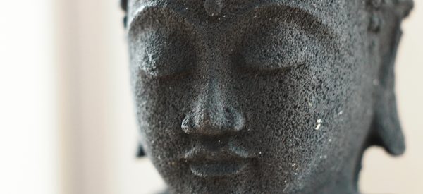close-up photo of a buddha statue's face for story on loving friendliness meditation