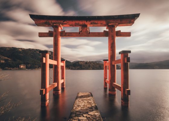 Photo of a gate in Japan, single white monk