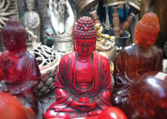 different buddha sculptures and religious items, mixing buddhism