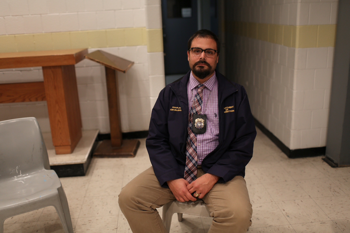 Chaplain Justin von Bujdoss sits in the chapel on Rikers Island