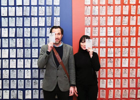 Project creators James A. Reeves and Candy Chang in front of A Monument for the Anxious and Hopeful