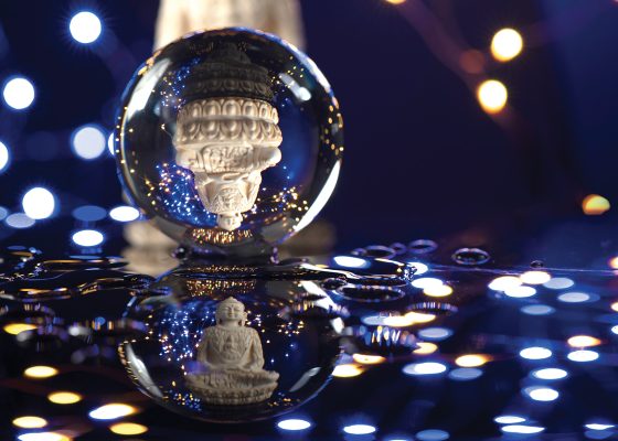 Buddha statue reflected in crystal ball samaya