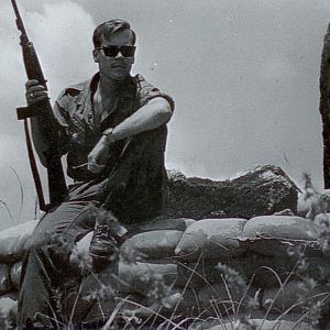 john steinbeck iv in military uniform holding gun