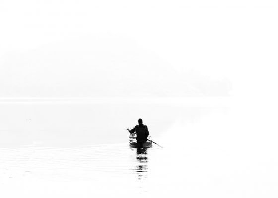 Enlightenment and dreaming; a silhouette of a boat against a white backdrop