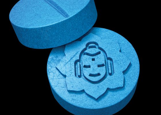 Pill with Buddha head imprinted, representing effect of mindfulness on health