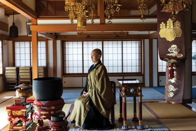 nun who converted from catholicism to zen sits in a zen monastery