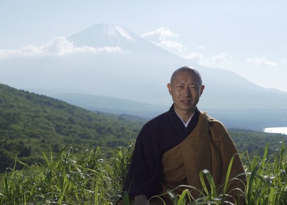 the monk chiken in front of mount fuji in the film tenzo