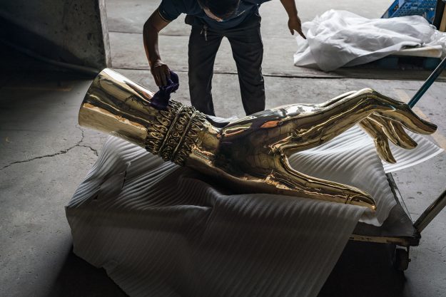 a brass hand from The Light That Shines Through the Universe