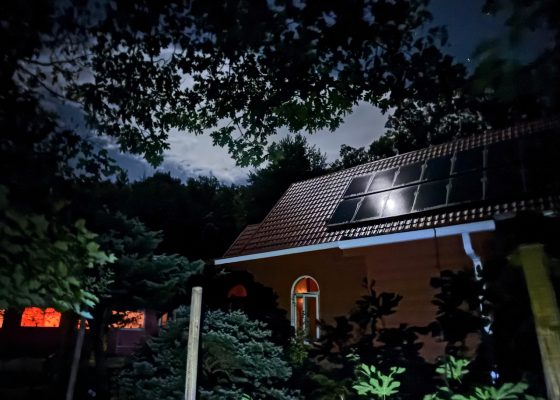 The moon reflects off the solar panels on Bhavana’s meditation hall as the 5:30 a.m. sitting approaches